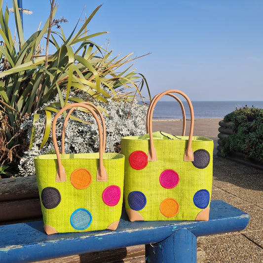 Lime Green Raffia Baskets decorated with rainbow coloured spots.