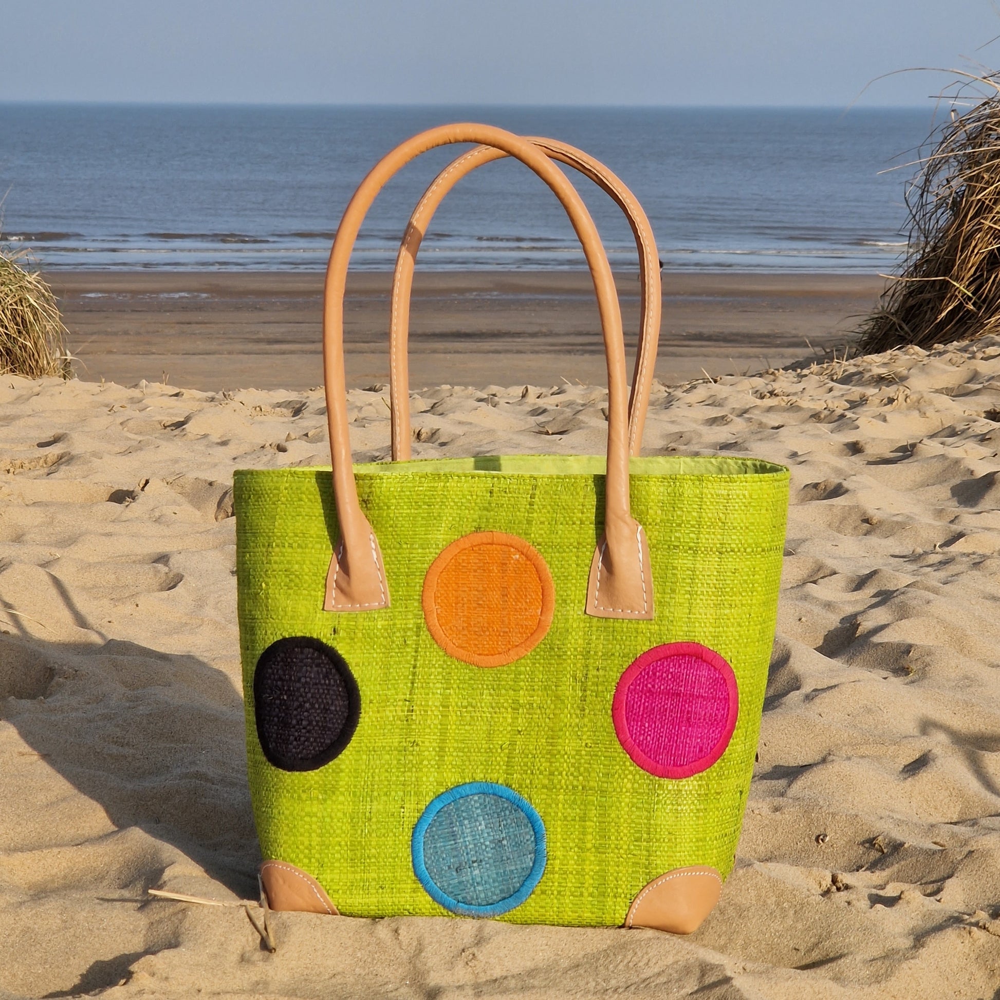 Lime Green Raffia Baskets decorated with rainbow coloured spots.