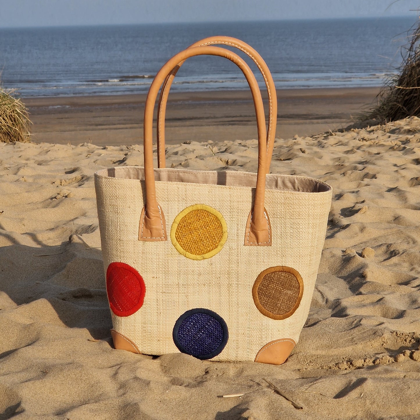 Natural Raffia Baskets with coloured spot pattern.