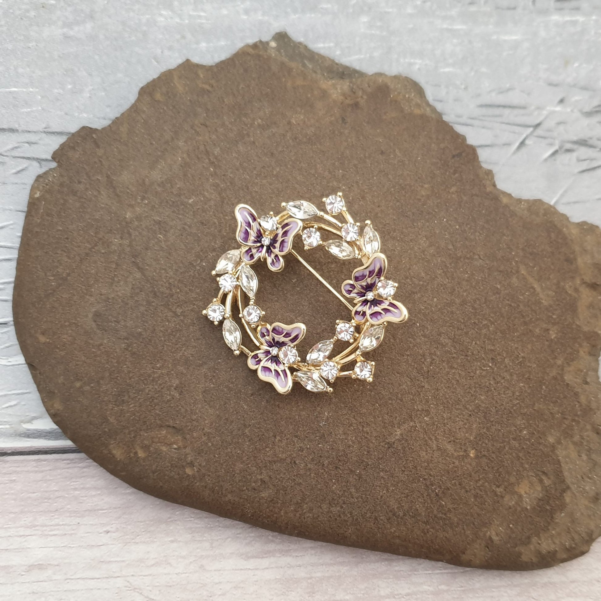 Golden mounted Brooch of Purple Butterflies and diamante crystal leaves.