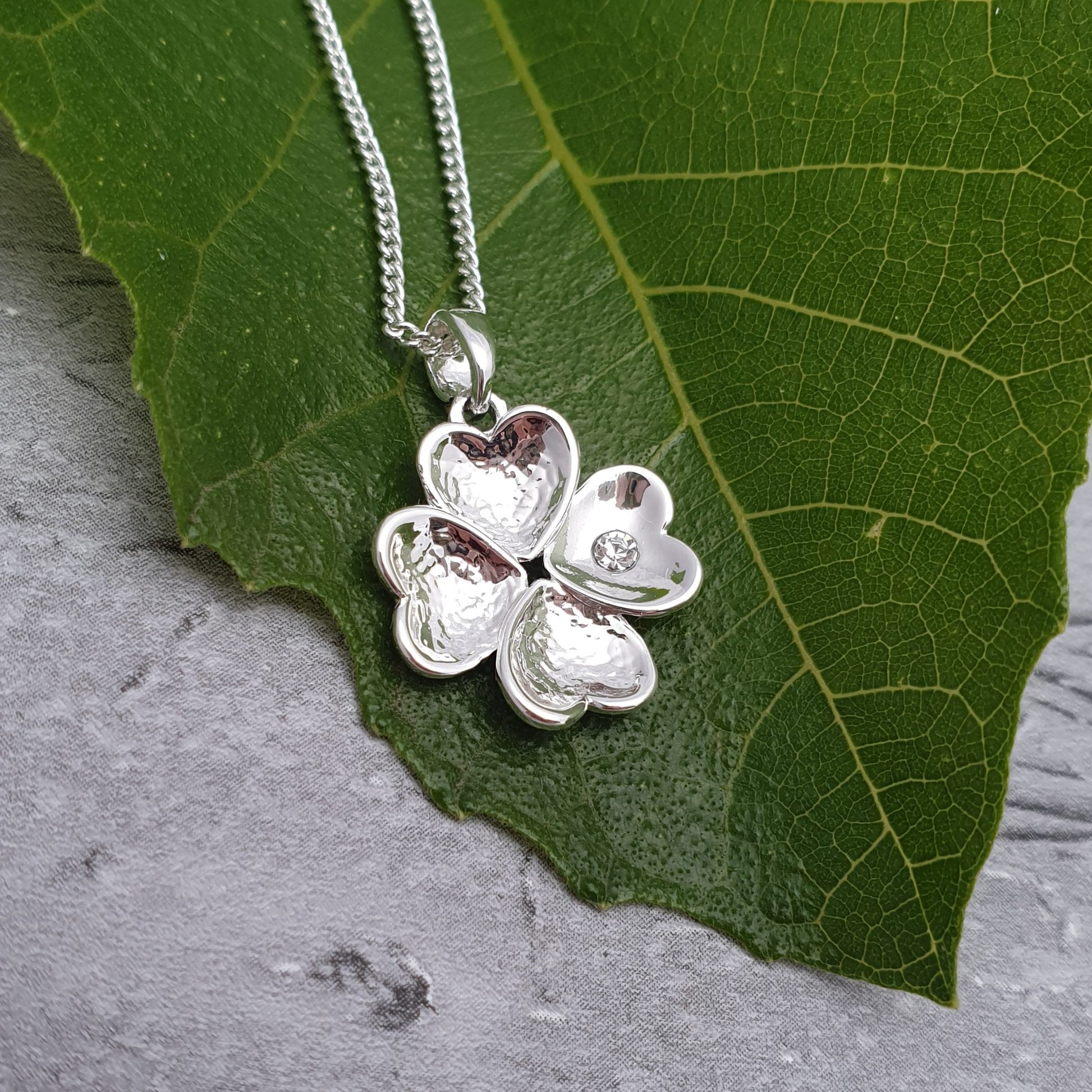 Four Love hearts conjoined to make a 4 leaf clover pendant necklace. Finished with a diamante crystal.
