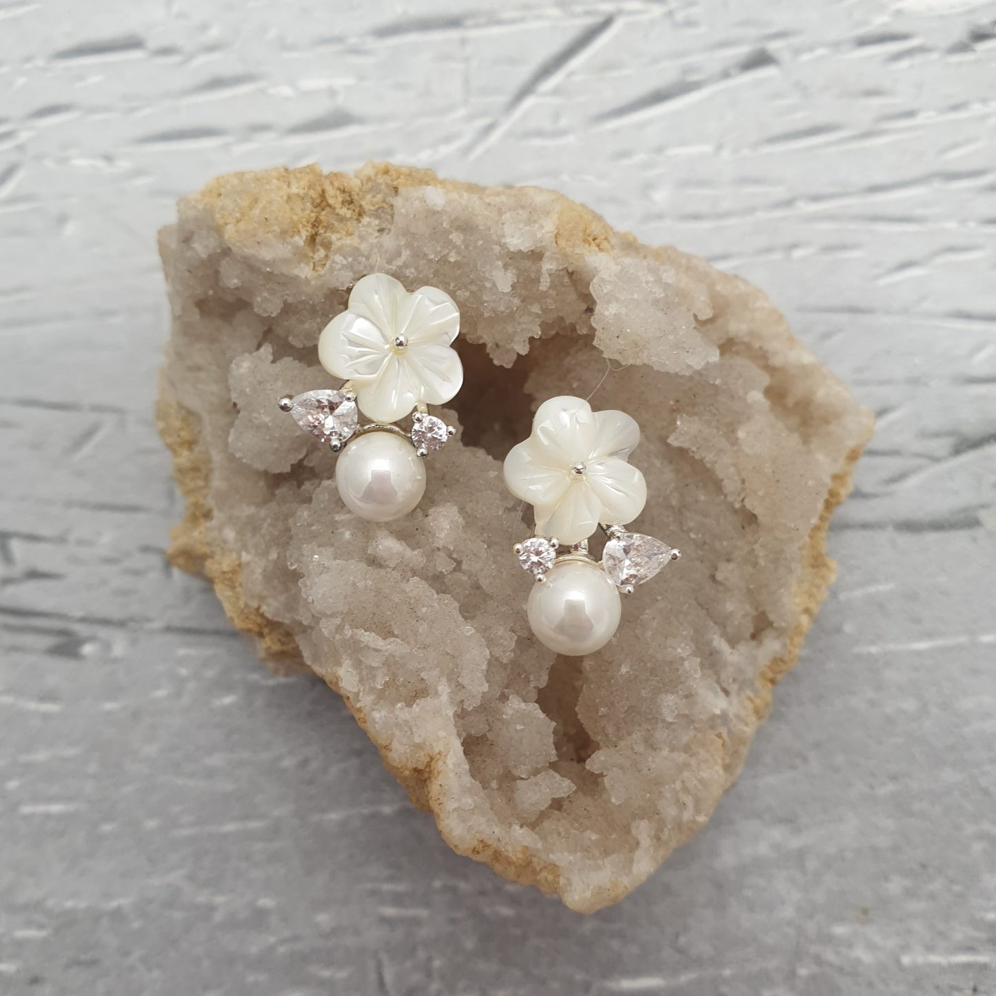 Mother of Pearl Earrings featuring dainty flowers with diamante crystal leaves set a top a creamy freshwater pearl