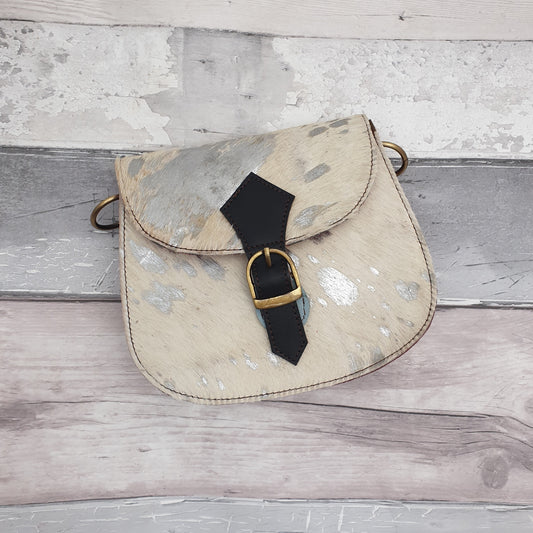 One of a kind bag made from leather off cuts with a textured front in cow hide. Silver metallic finish with brass fixings.