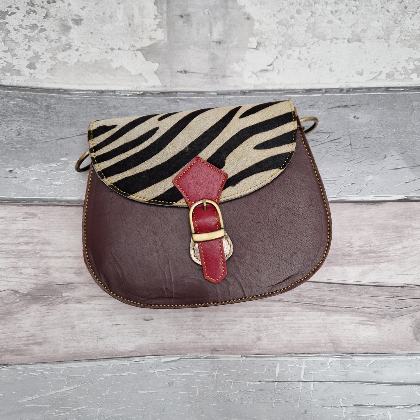 All leather bag made from leather off cuts in different colours and with a textured animal print panel.