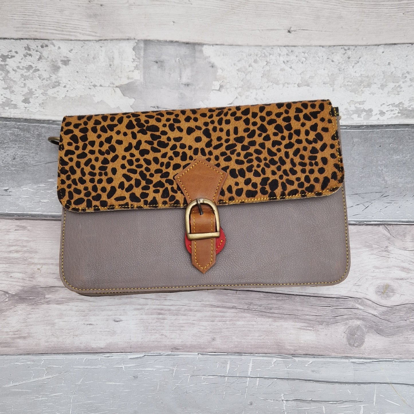 Grey leather handbag featuring a textured Cheetah print panel.