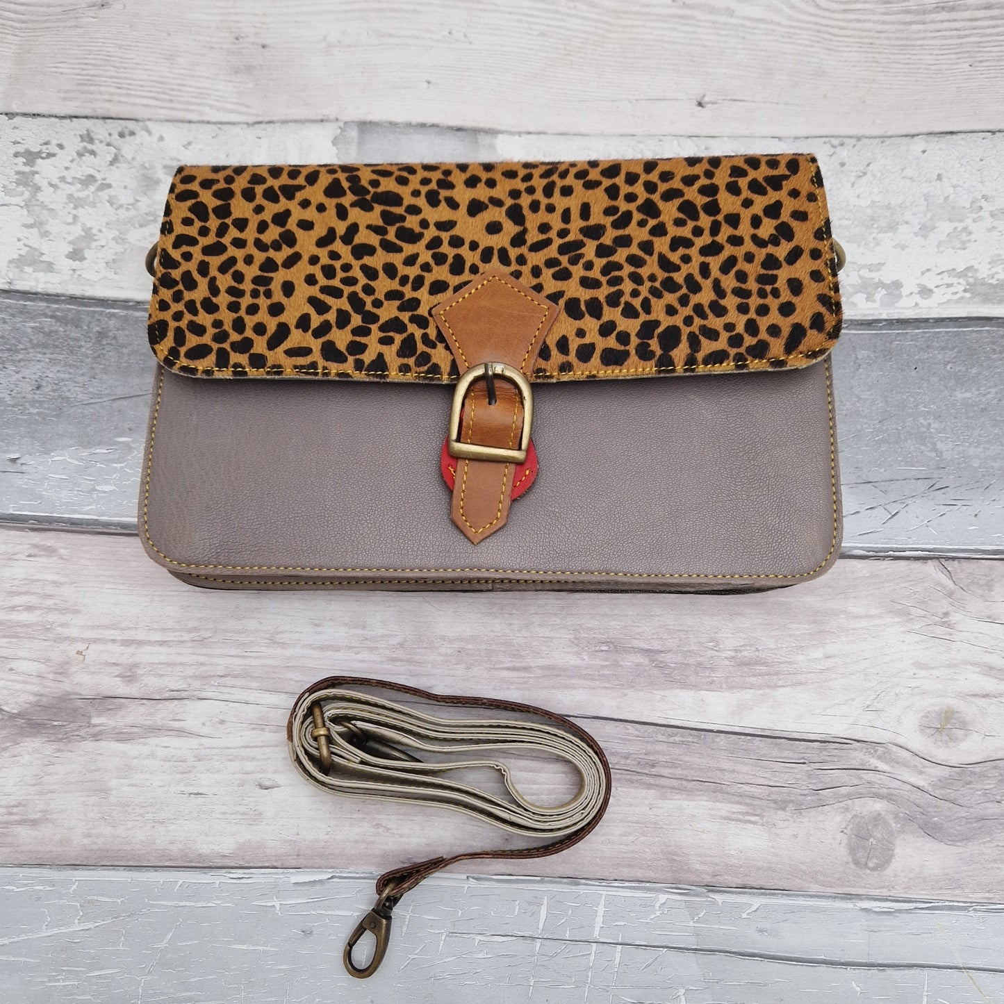 Grey leather handbag featuring a textured Cheetah print panel.