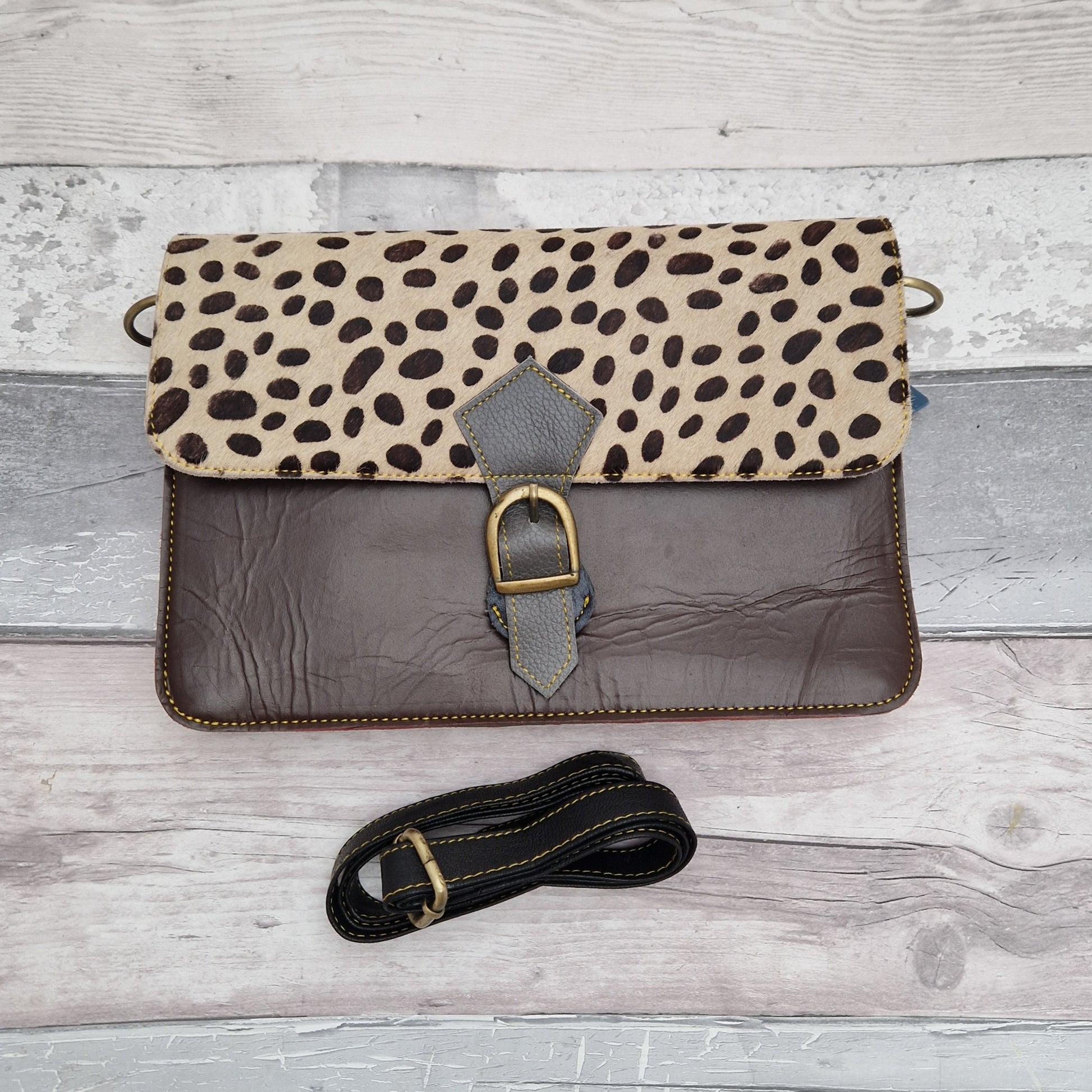 Chocolate coloured leather bag with a textured spotty print panel.