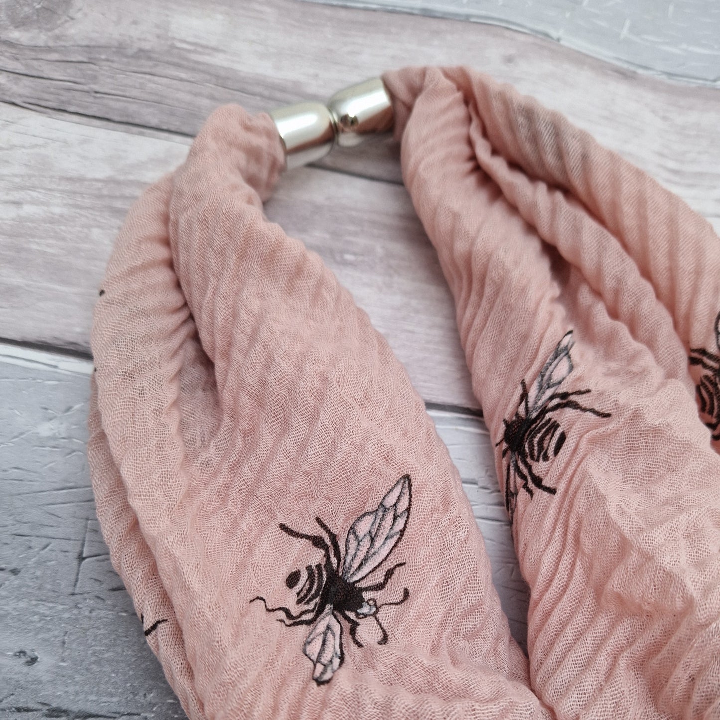 Pink crinkle neck scarf with bee print.