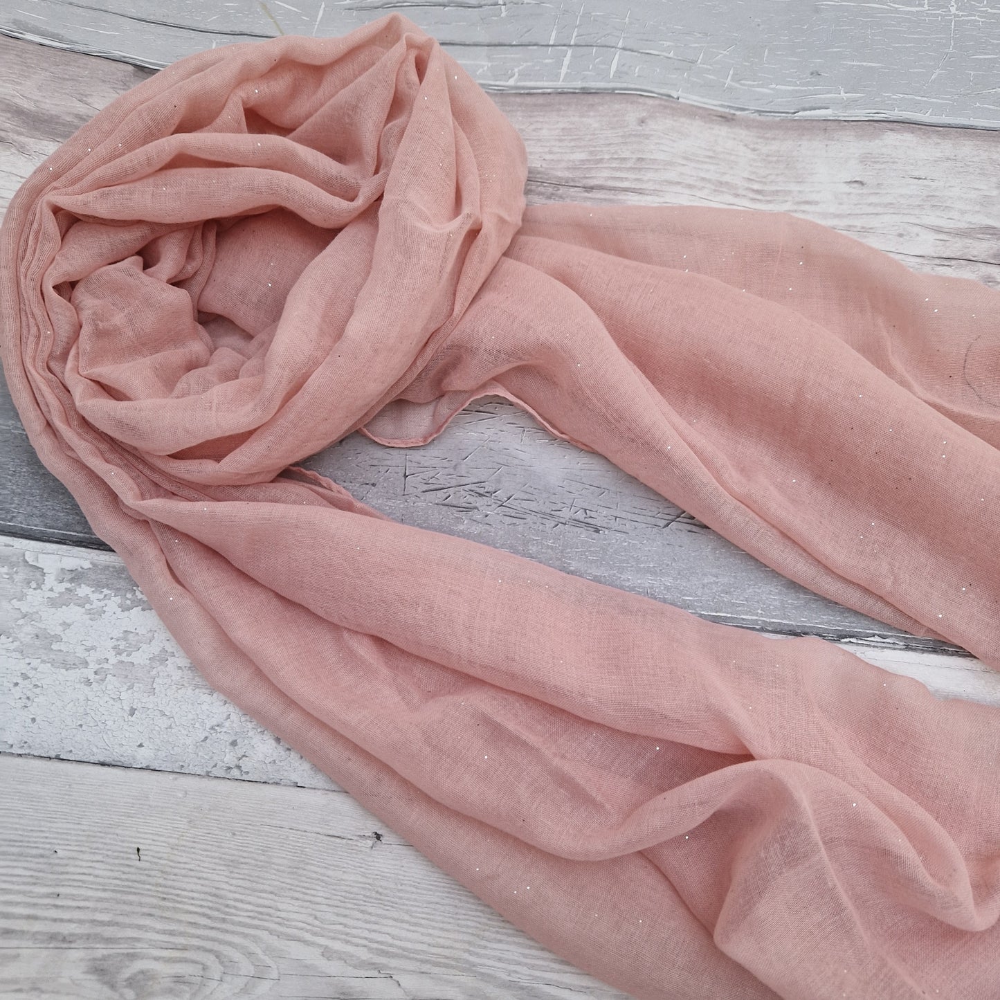Pink scarf with a glitter sparkle finish.