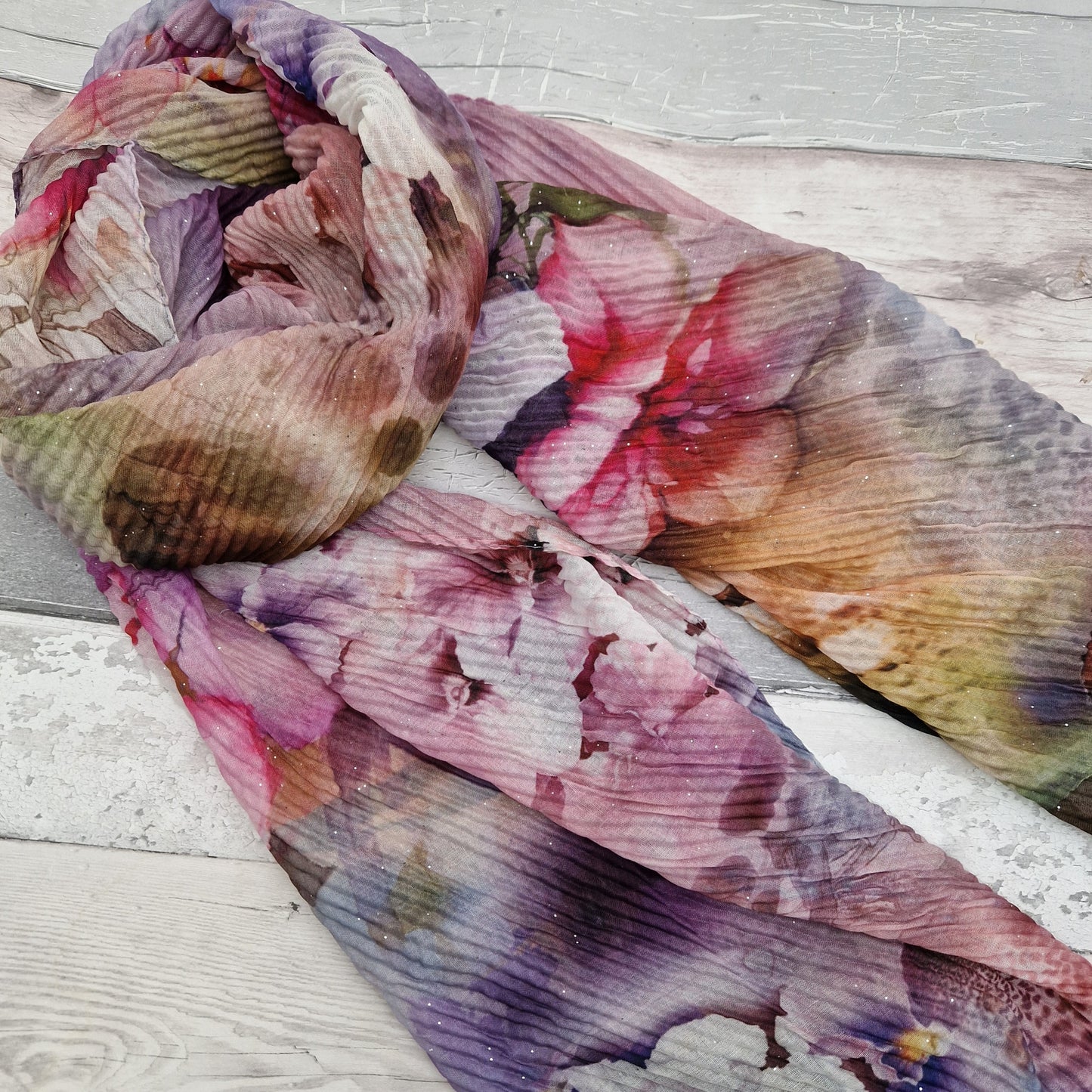 Crinkle finish scarf featuring pink tone bouquet of flowers.