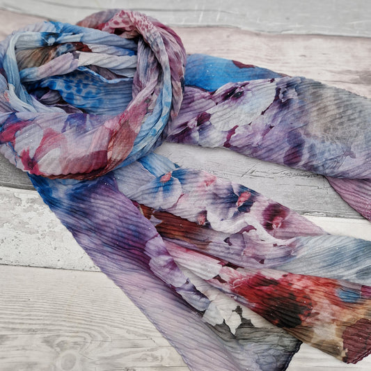 Crinkle scarf decorated with a bouquet of flowers in colours of blue and purple.