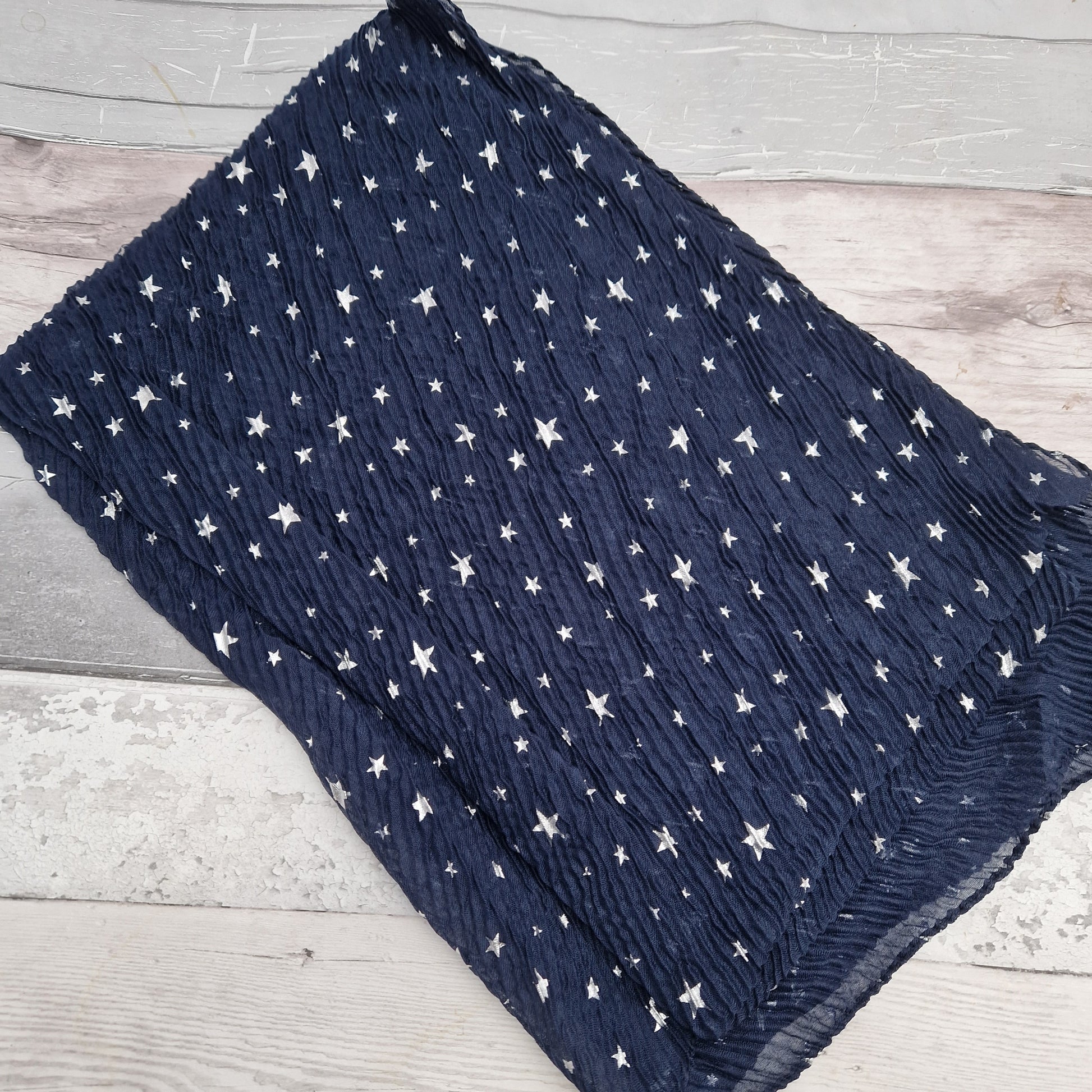 Navy crinkle finish scarf decorated with silver metallic stars.