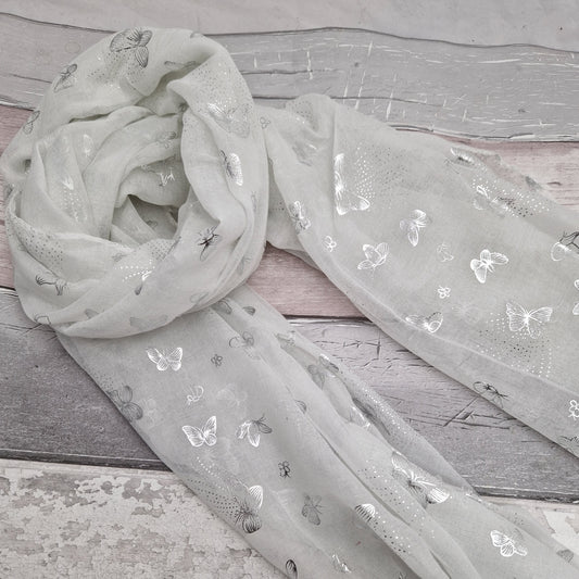 White scarf decorated with metallic silver butterflies.
