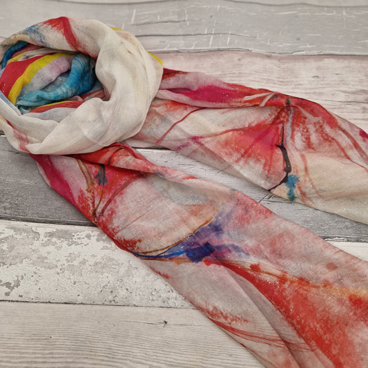 Lily print scarf in red, yellow and blue colours. Finished with silver sparkles.