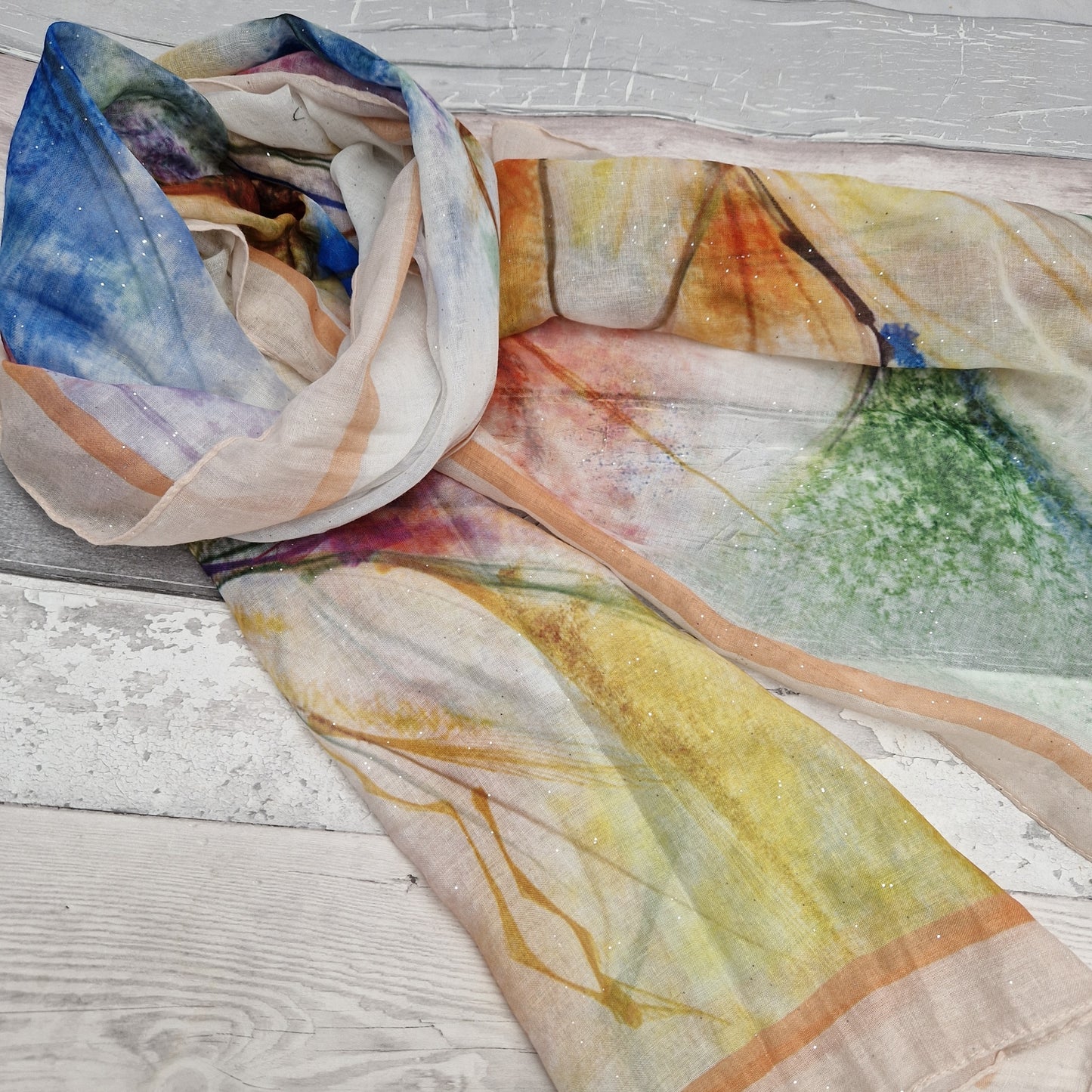 Lily print scarf in pretty mixed colours. Finished with a silver sparkle.