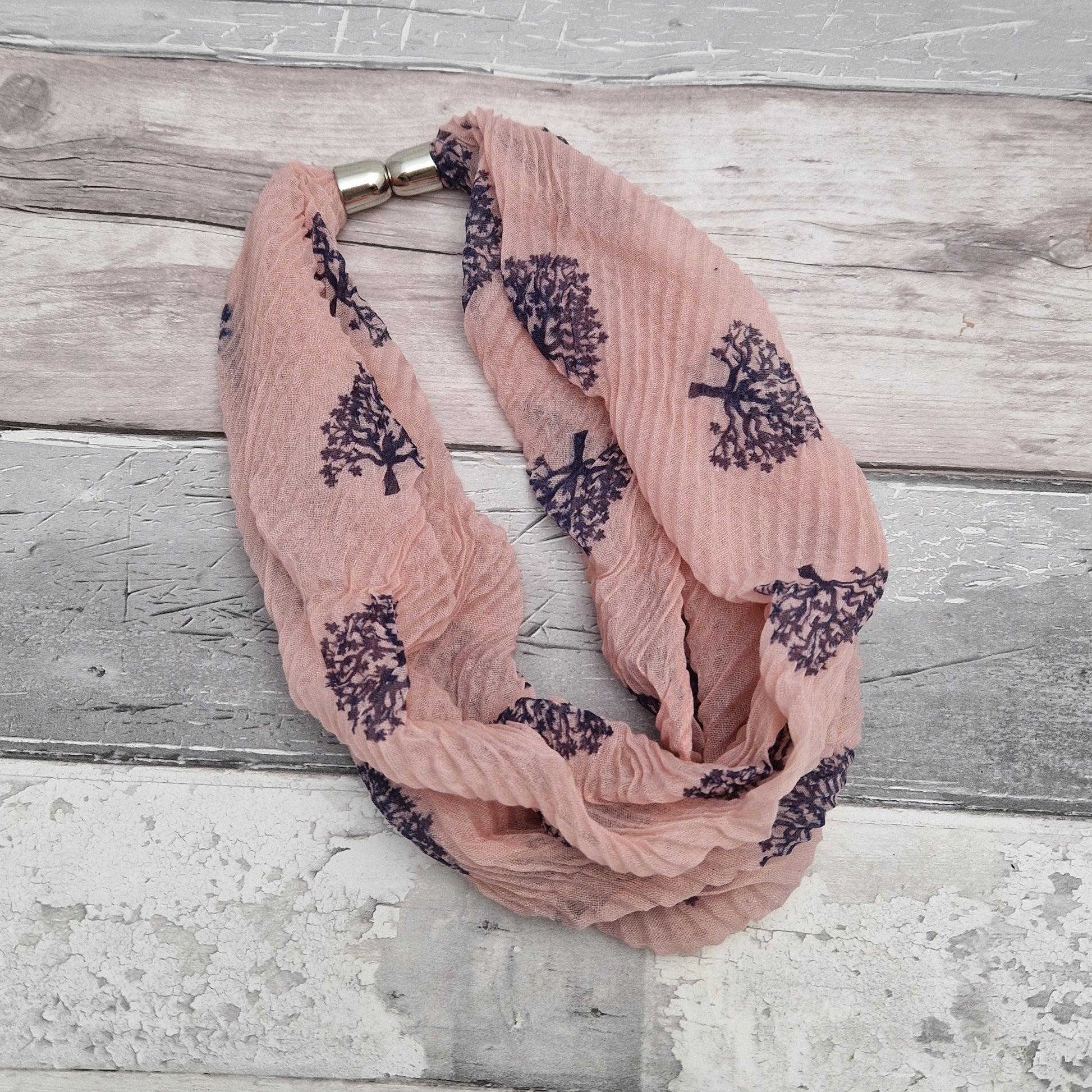 Pink neck scarf with a navy tree of life print.