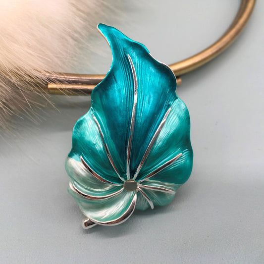 a vibrant turquoise coloured leaf brooch