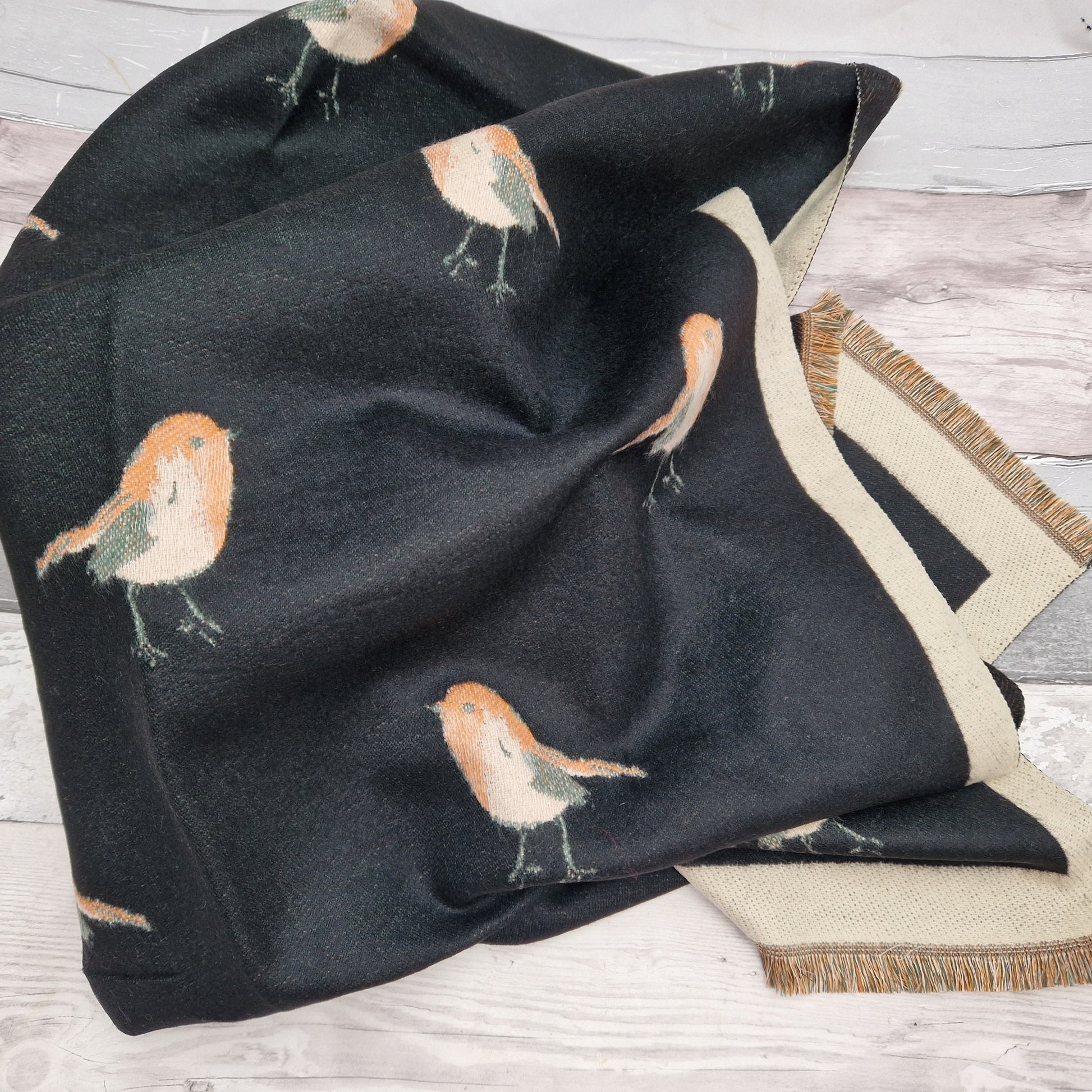 Black scarf with a sand coloured trim, decorated with garden Robins.