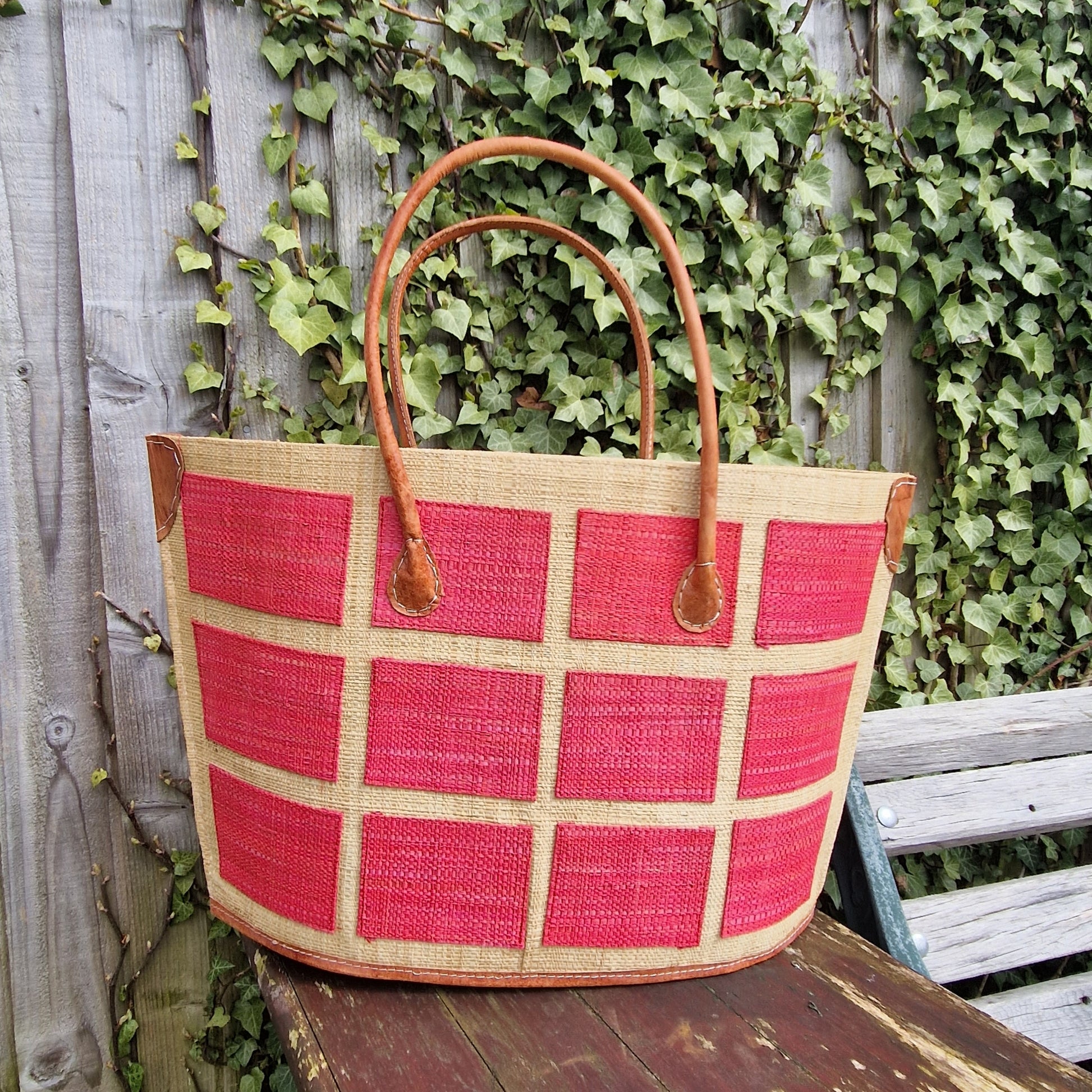 Bato style raffia basket decorated with strawberry red coloured squares.