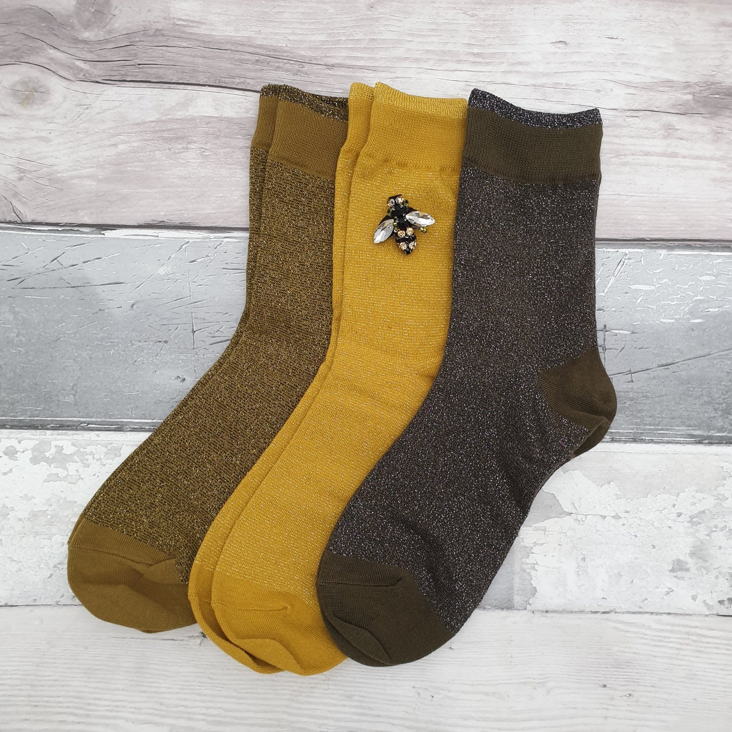 3 Pairs of Sparkly socks in Yellow, Olive and Pewter with a Glass Bee Brooch.