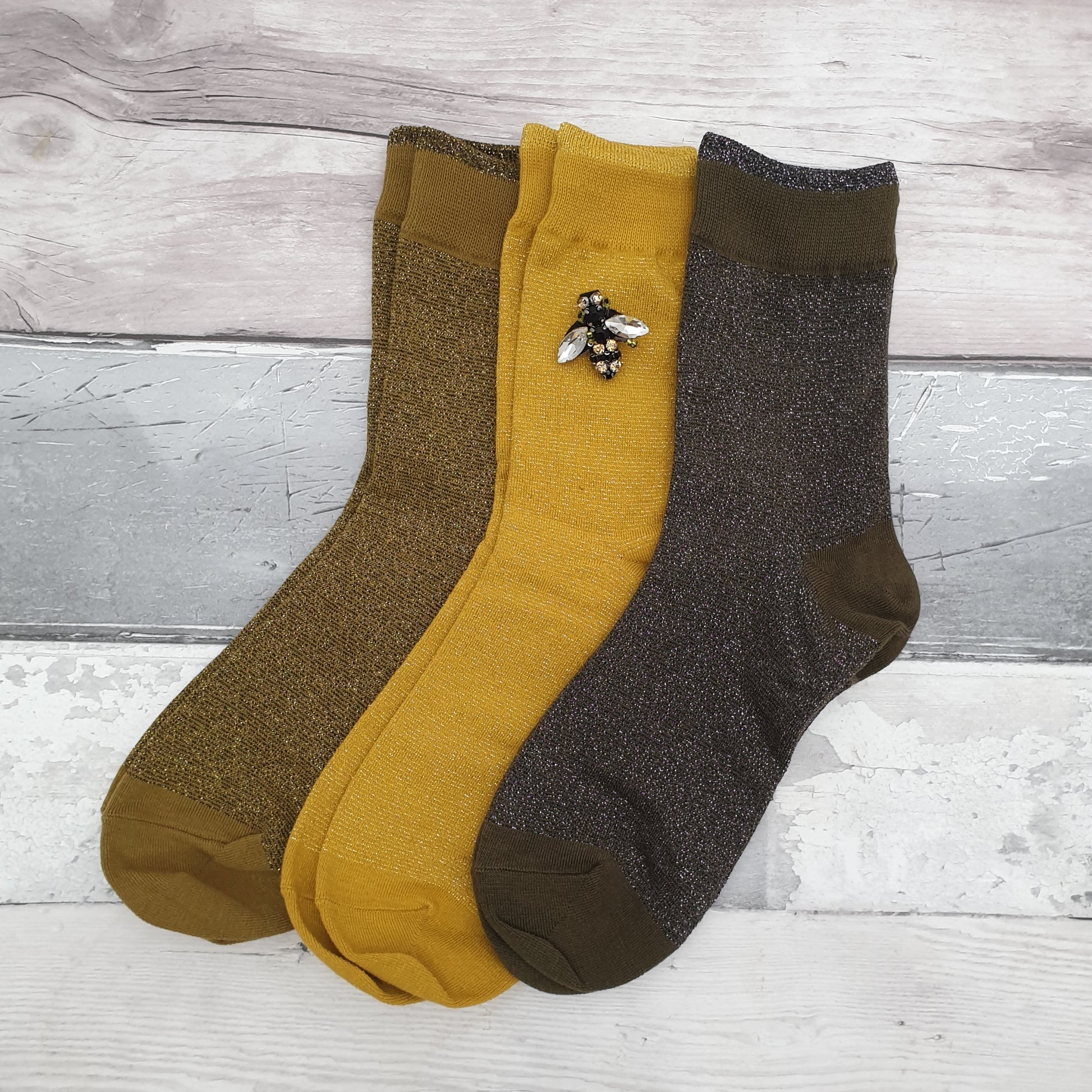 3 Pairs of Sparkly socks in Yellow, Olive and Pewter with a Glass Bee Brooch.