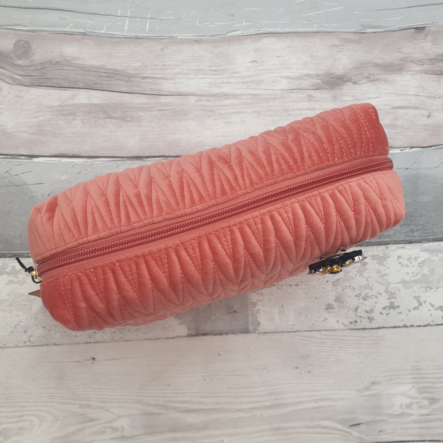 Salmon Pink coloured washbag in quilted velvet with a removable Bee Brooch in Black and Gold.