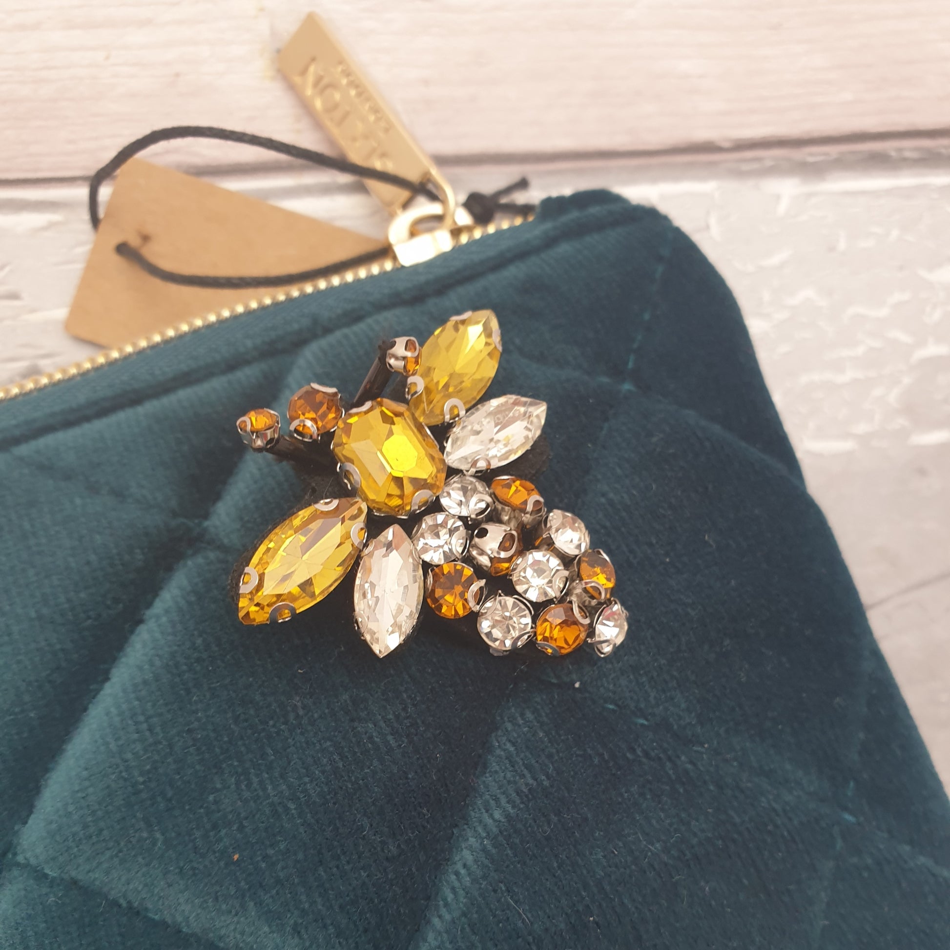 Teal Blue Make Up Bag made from quilted velvet with a Glass Bee Brooch in Gold.