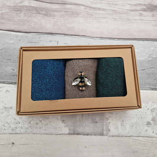 Set of 3 gift boxed sparkly socks in denim, teal and sand. Complete with a glass bee brooch.