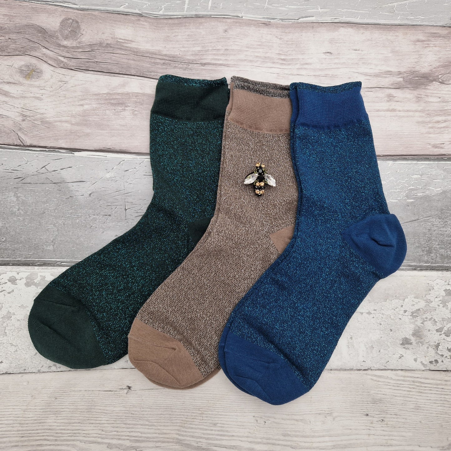 Set of 3 gift boxed sparkly socks in denim, teal and sand. Complete with a glass bee brooch.