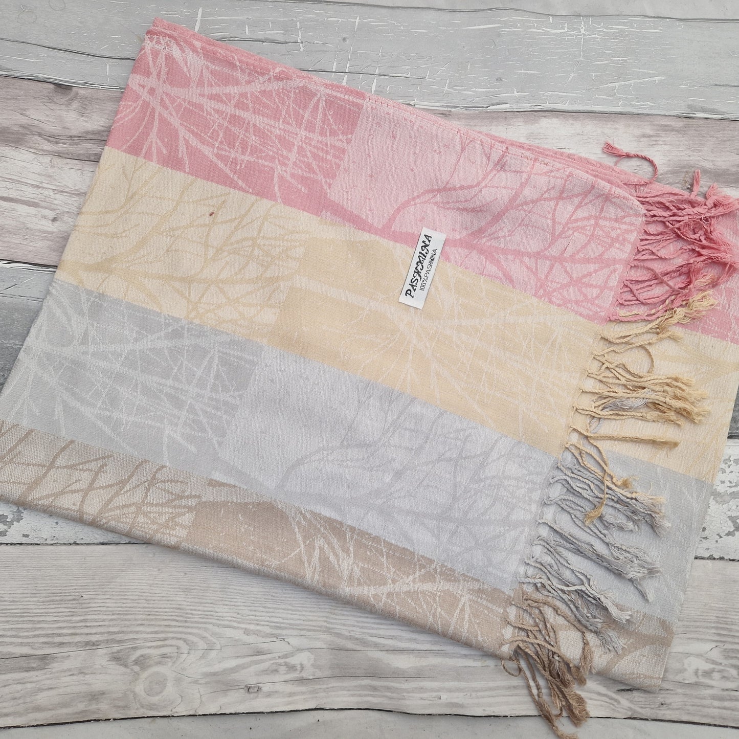A Neapolitan of pink, lemon and silver bring this beautiful woodland scarf to life.