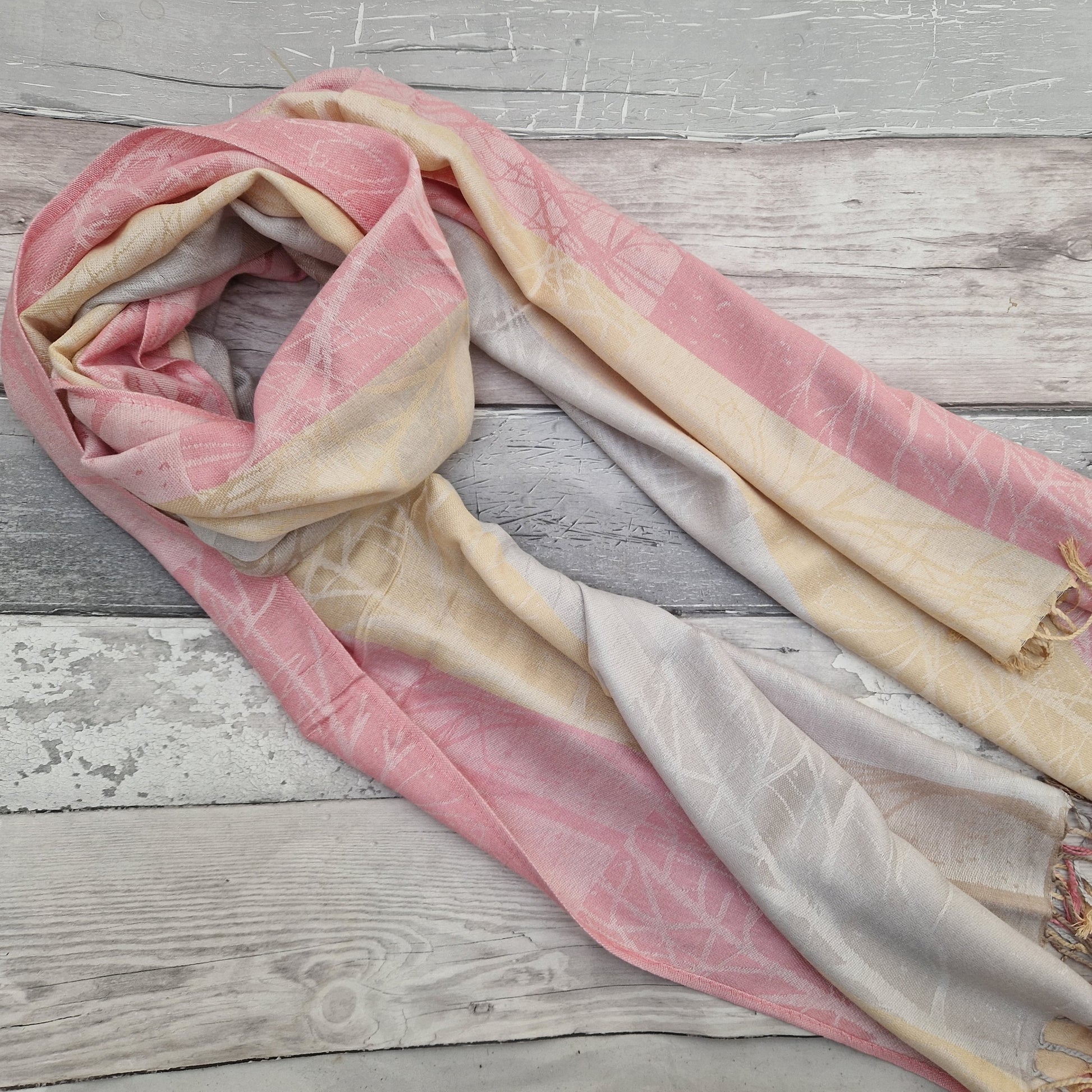 A Neapolitan of pink, lemon and silver bring this beautiful woodland scarf to life.