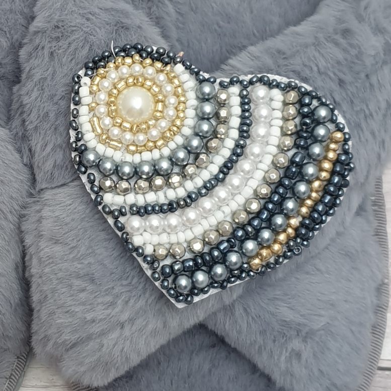 Heart shaped brooch covered in pearls and beads