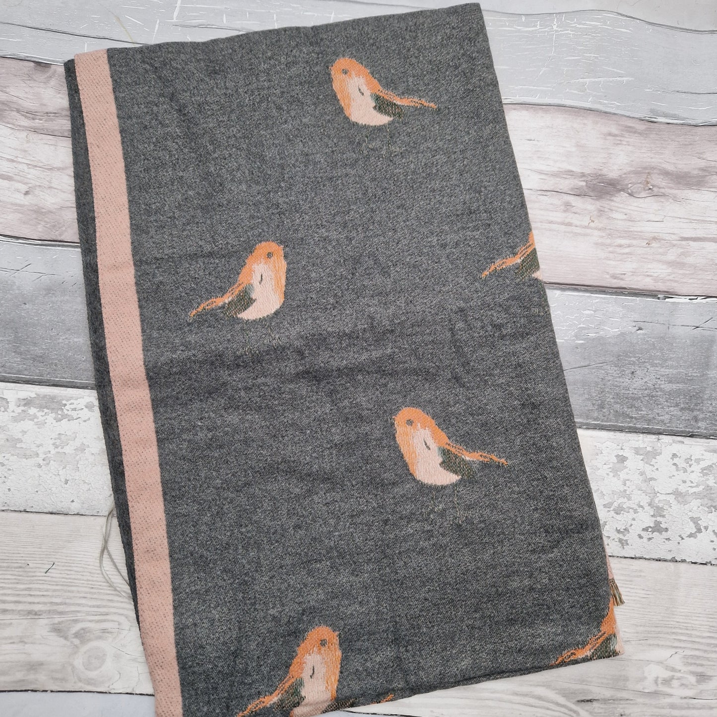 Grey and pink coloured scarf decorated with Robins.